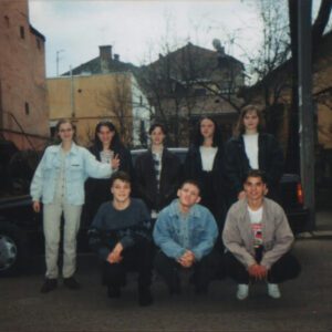 Group of Ukrainian children posing outside at summer camp, labeled with sibling names.